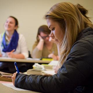 A student takes notes in class