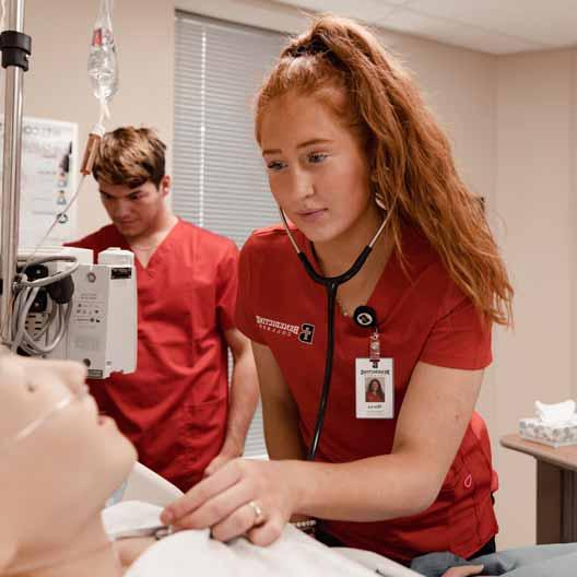 Nursing students practicing taking care of a patient